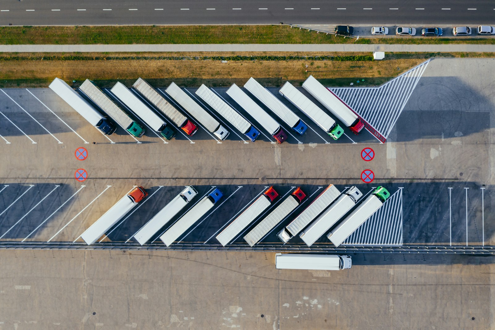Aerial view of a fleet of trucks parked in rows at a depot